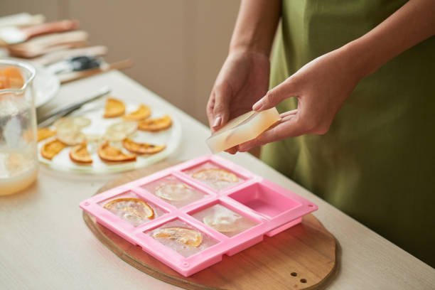 Woman taking soap bars out of plastic form