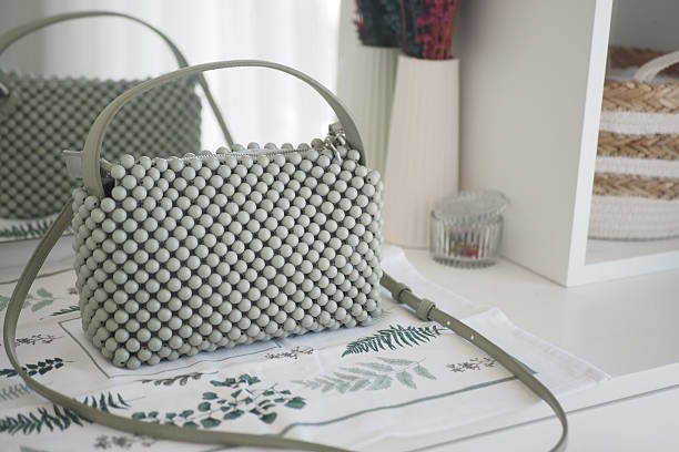 A trendy green handbag showcasing a unique and intricate bead design, ideal for any outfit